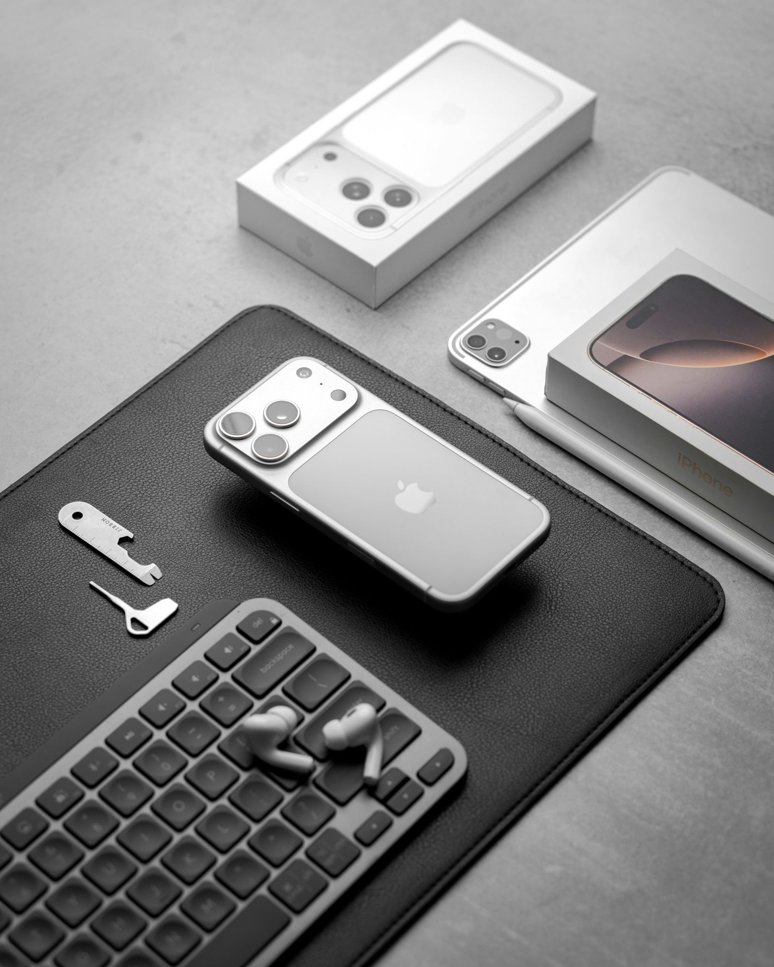 Apple iphones and accessories arranged on a surface.
